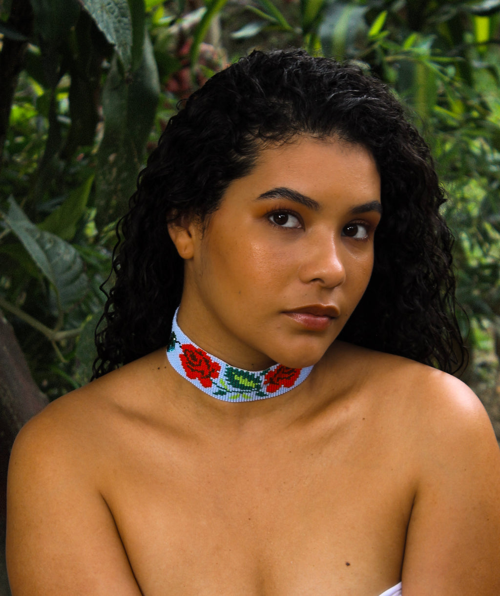 Woman wearing a colorful choker necklace in a natural setting